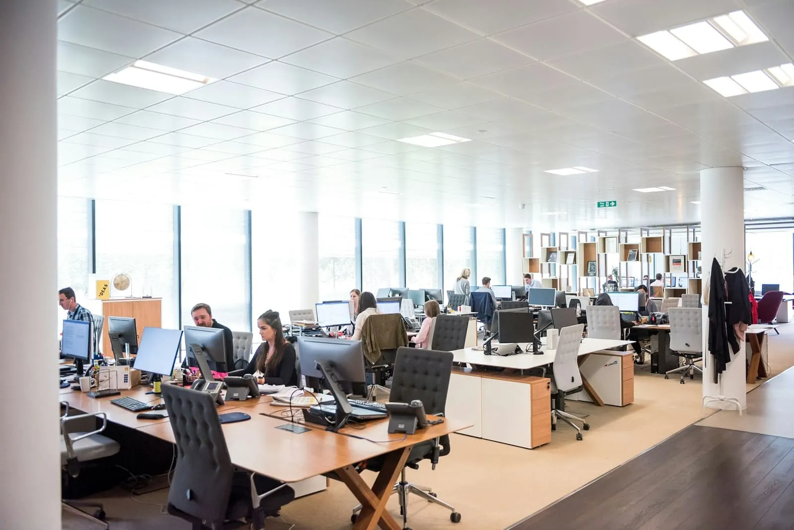 Agents at their desks on a bright contact center floor